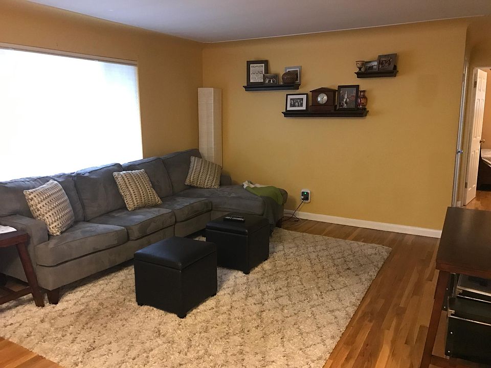 Living room. Shelves stay for you! Huge front window lets in tons of light. Cordless fabric blinds on all windows insulate the temperature.