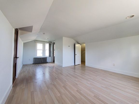 Another view, master bedroom. Door to upstairs foyer on left. Door to walk-in closet, under eaves storage on right. En suite bathroom in center.