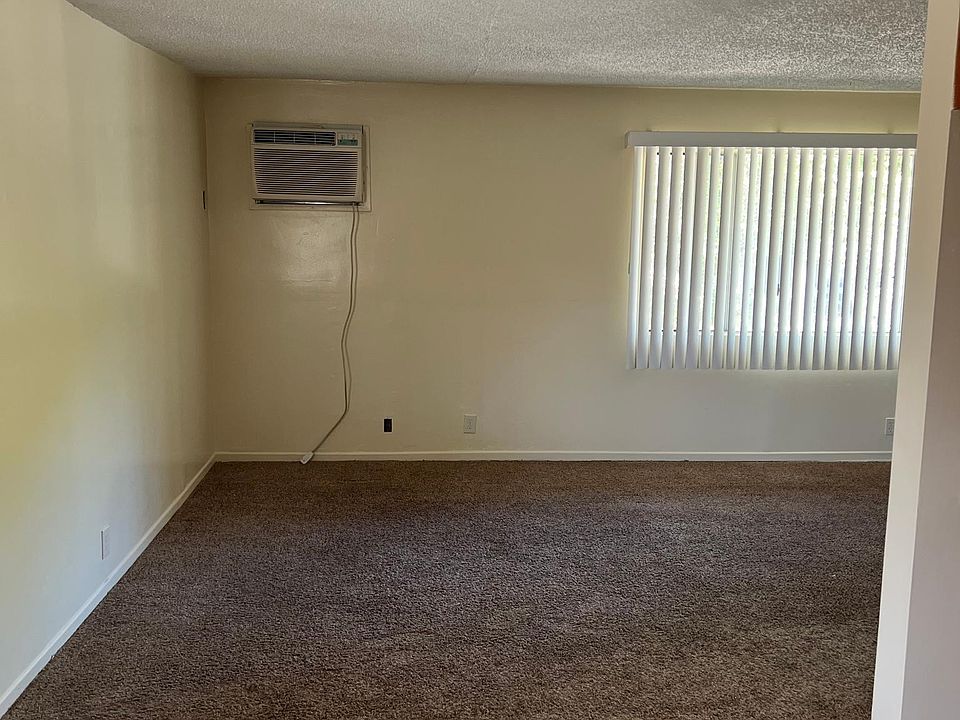 Living room. In wall a/c unit.