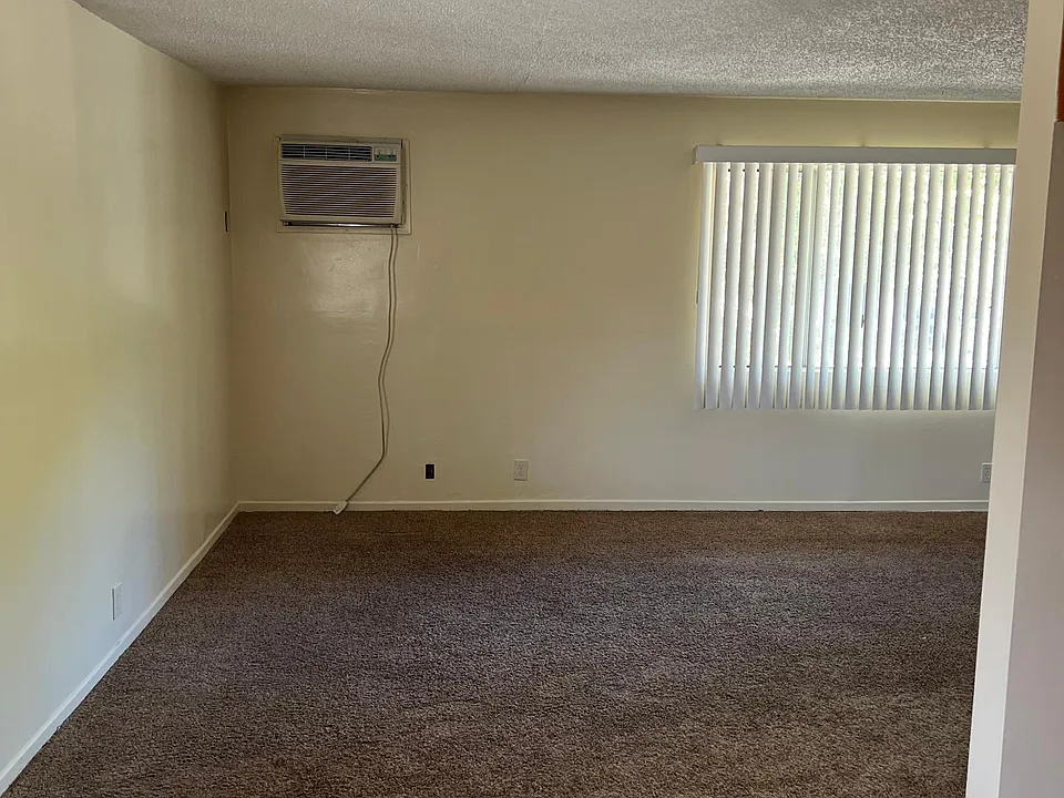 Living room. In wall a/c unit.