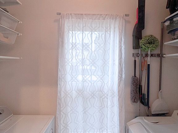 Laundry room with shelving and storage