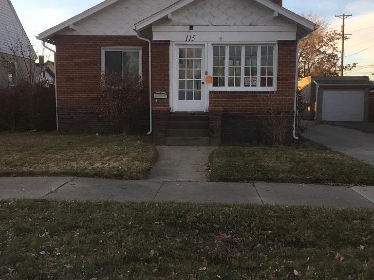Beautiful front lawn and enclosed sun room in front.