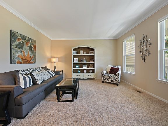 Overlooking the front porch, a formal living room is one of many rooms in the house that is perfect 