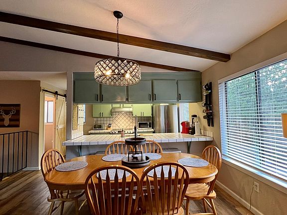 kitchen table actually seats 8. leaf and two extra chairs are in garage for days when you need the additional seating.
