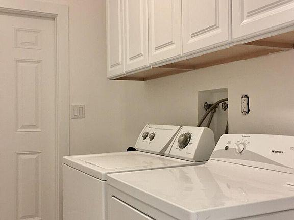Large laundry room in unit with plenty of cabinet space