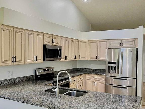 Updated kitchen and appliances with granite and solid wood kitchen cabinets. Natural light from skylight