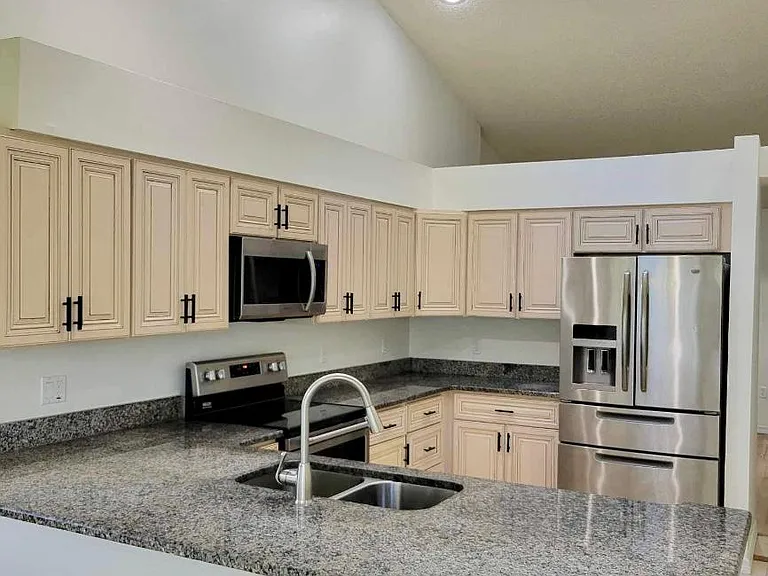 Updated kitchen and appliances with granite and solid wood kitchen cabinets. Natural light from skylight