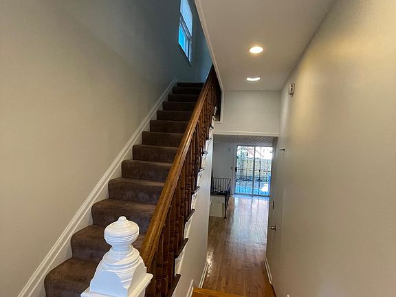 Bright, welcoming entrance hallway leads into open living area and staircase to the second floor