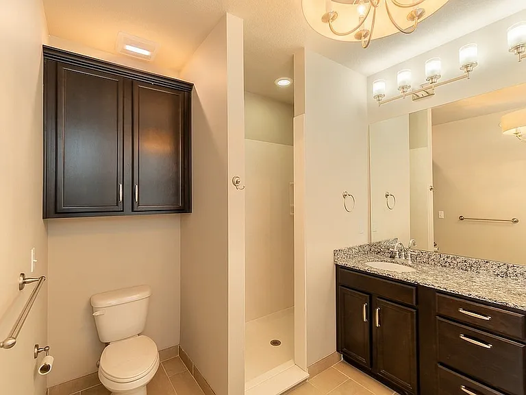 Bathroom with Cultured Marble Walk-in Shower and Granite Countertop