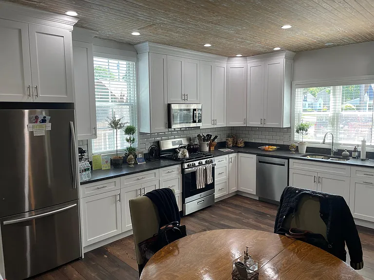 High end kitchen with stainless appliances, granite counters, custom cabinets and plenty of natural light.