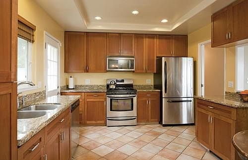 Full kitchen with stainless steel appliances and heated tile
