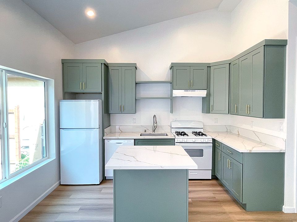Full kitchen with island, 14' high ceilings, large windows