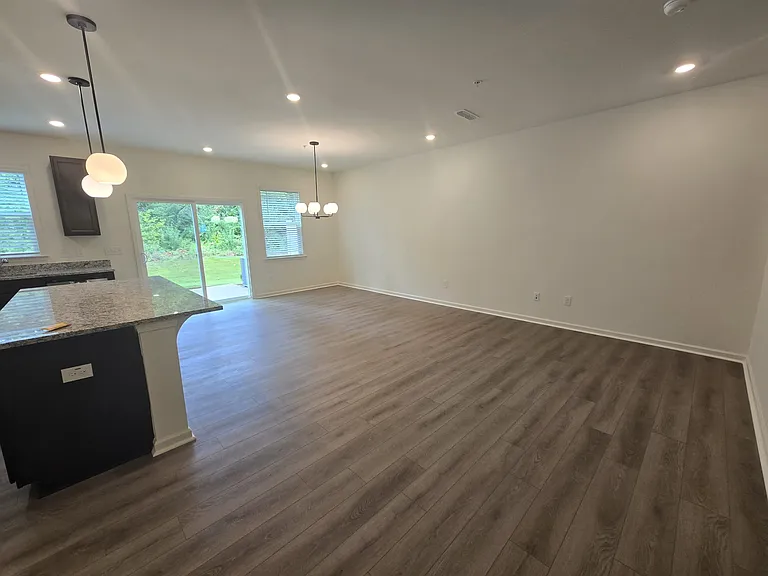 View from the kitchen of the living room and sliding door to the back porch