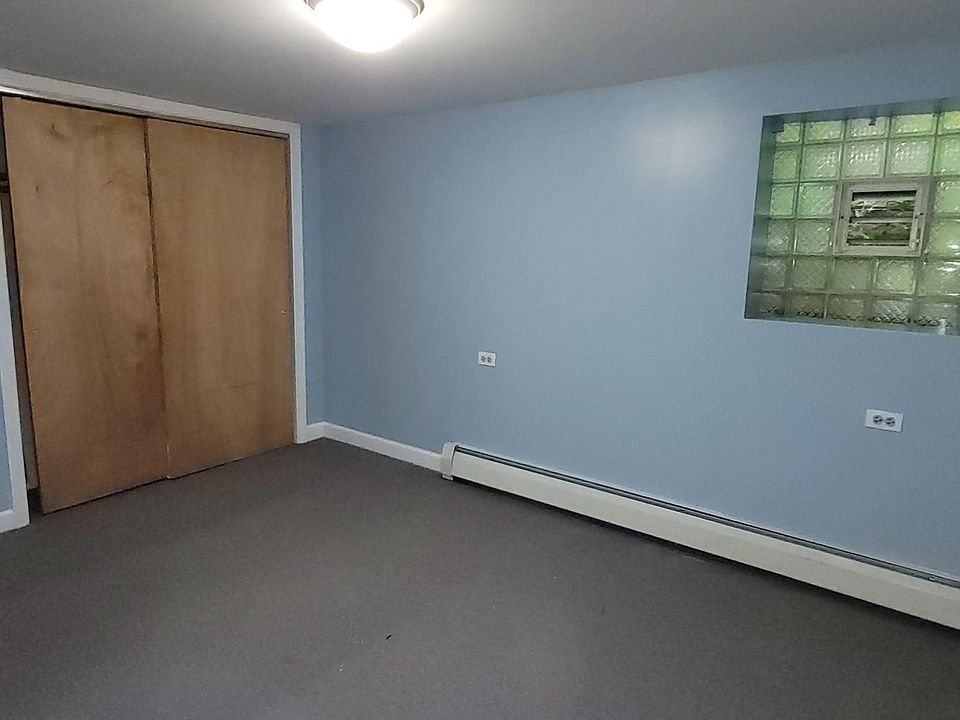 Carpeted bedroom with full wall closet