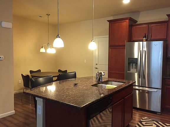 Kitchen w/ view of dining and attached 2 car garage access