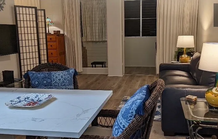 Open floor plan. Looking from kitchen table to living room side entrance of back lanai