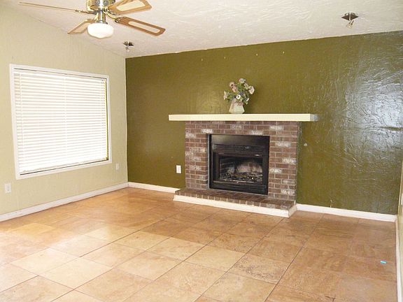 Huge family room with new travertine floor, cozy fireplace and french doors 