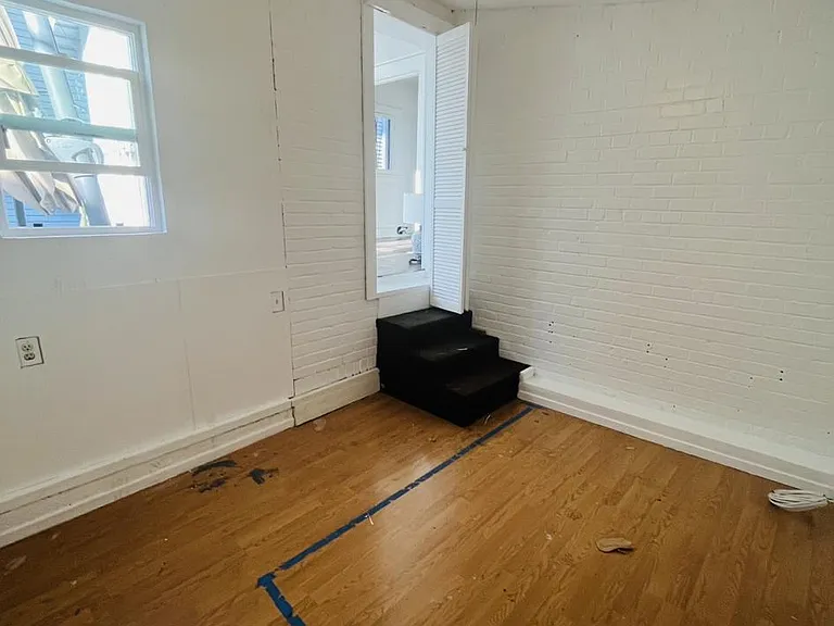 Downstairs bedroom, with window viewing into the deck area.