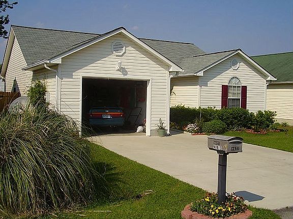 View of extra-wide one car garage and 2 car driveway