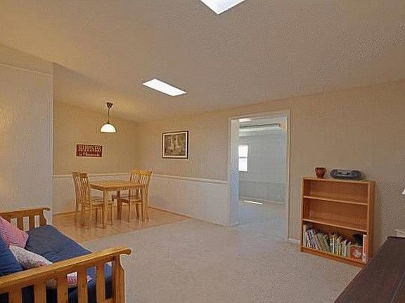 Living/dining (older photo, flooring and wainscotting in dining has been updated)