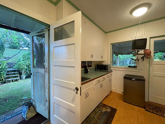 Bar sink, side door and backdoor to covered patio