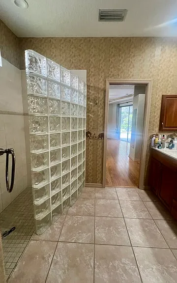 Primary bathroom features pocket doors, private water closet, walk in shower, dual sink vanity with storage, and a jacuzzi jetted tub.