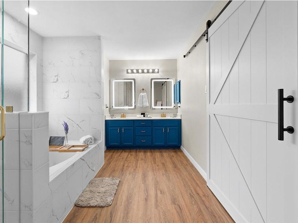 Master en-suite. 2 sinks, Jacuzzi tub, separate walk-in shower, separate toilet. Barn doors to your right lead you to a hidden dressing room with a vanity.