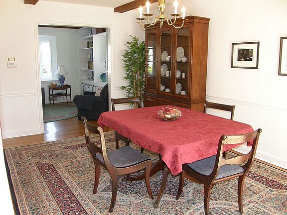 Spacious dining room with beamed ceiling off of the living room 