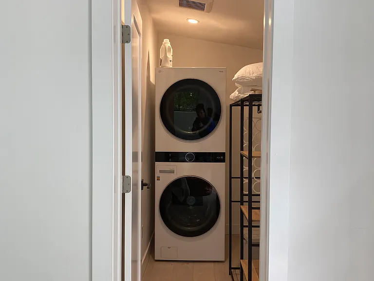 Full size washer and dryer in walk in closet off bedroom