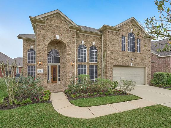 One more view of the front of this stately home showing the cathedral windows and brick elevation. Nice archicetural lines. There is an extra 5' extension on the garage for storage, with a window to the front and door to the back yard, which is truly