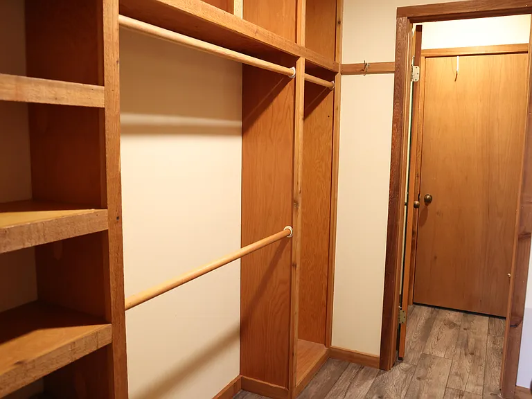 Spacious walk-in closet with built-in shelving and ample storage to keep your wardrobe organized.