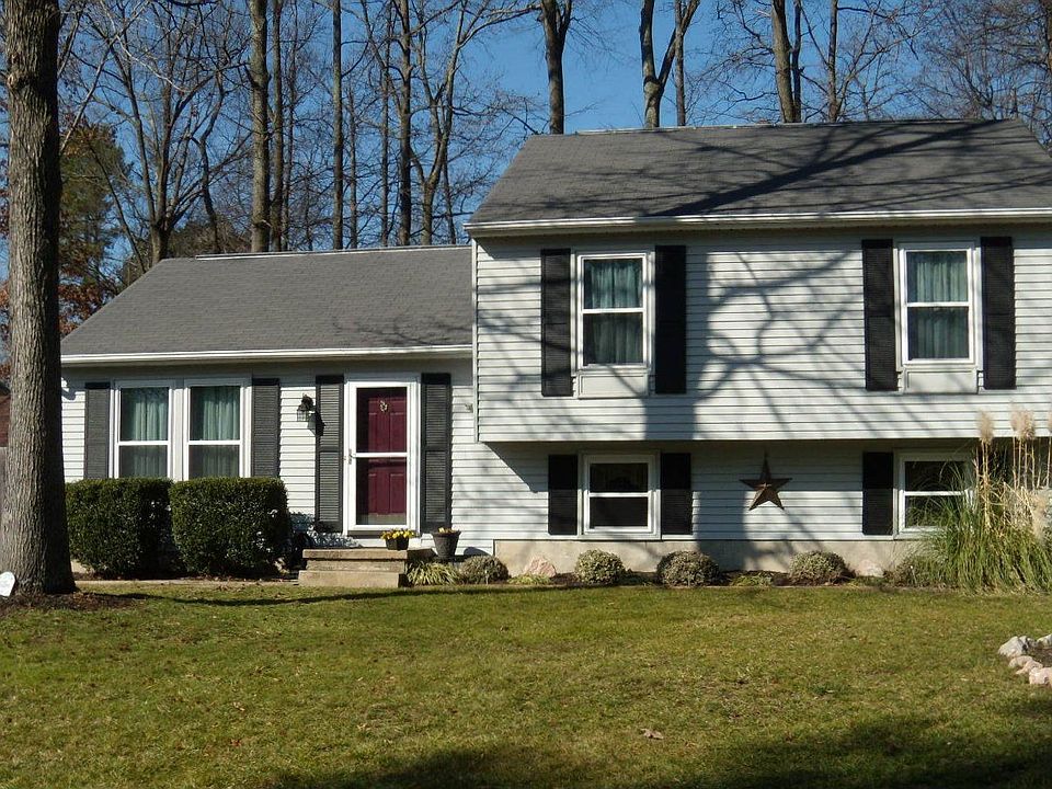Vinyl siding, paved driveway, fenced yard.
