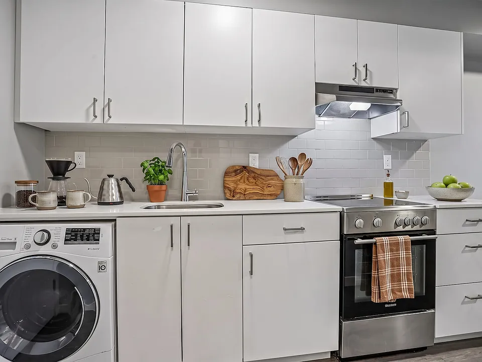 Full-size in-unit laundry built into the kitchen run - no shared machines, no waiting.