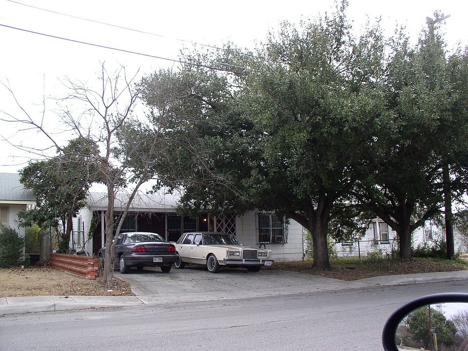 Front of house showing large trees