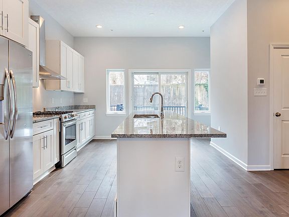 Kitchen with walk out deck, new granite countertops, new stainless steel appliances, and convenient half bath