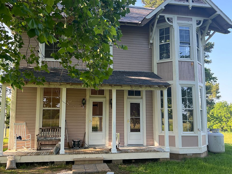 Front of house with porch and bay windows.