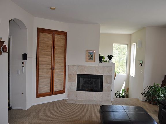 Living room 14x14, custom made wooden entertainment center, Berber carpeting 