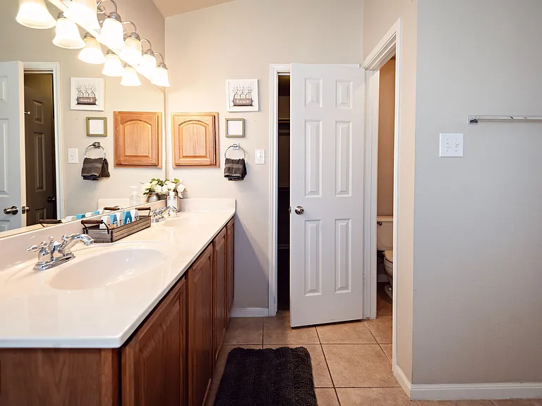 Spacious bathroom with a long double-sink vanity, generous counter space, and ample storage for daily essentials.