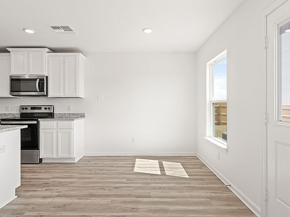 The dining room has a door that leads to the back yard