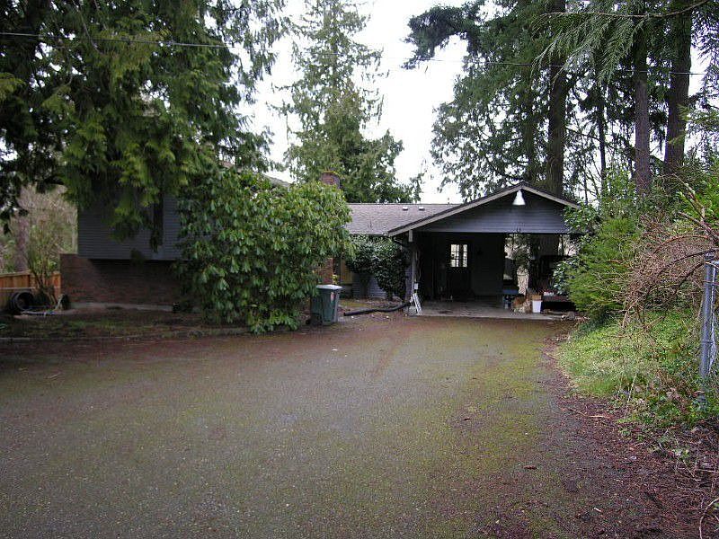 Welcome home! Carport attached to home with detached garage.