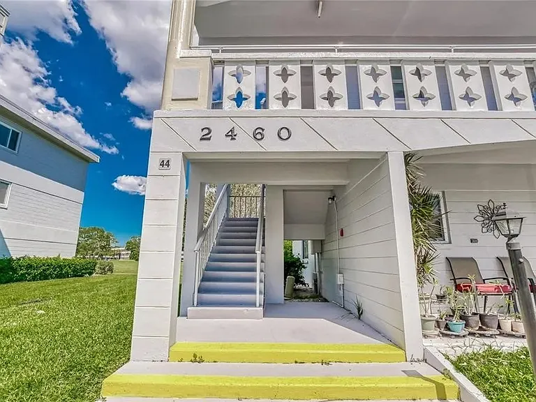 Stairway leading from the parking space up to the condo. There is an elevator at the center of the building.