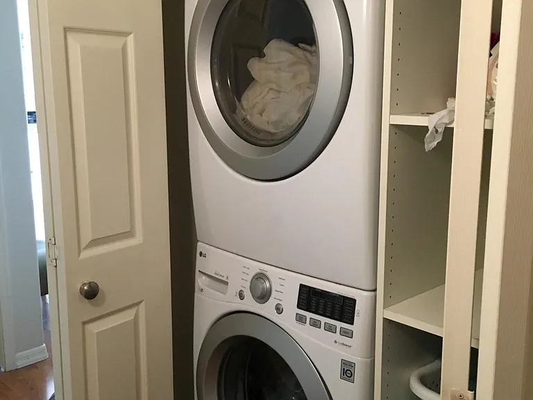 Stackable washer and dryer with shelves for storing and sorting laundry.