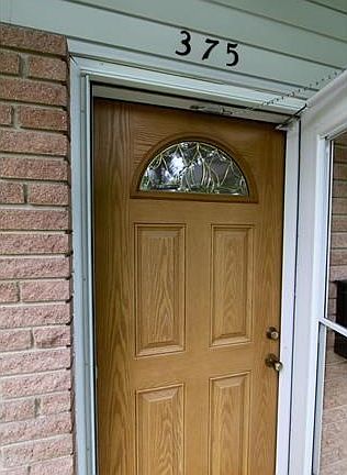 Beautiful 4 panel door with great stained glass feature. There is also a storm door allowing you to 