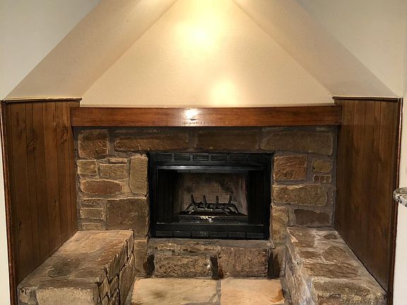 Wood burning fireplace with mantle and sitting area