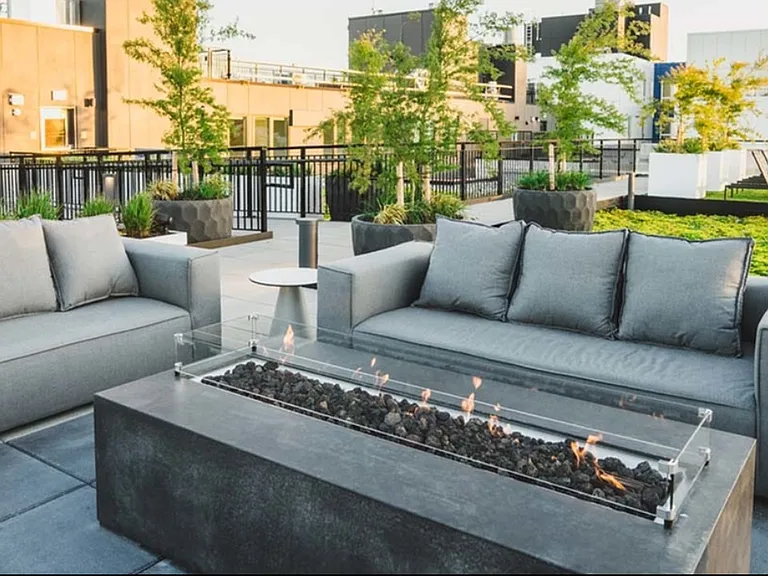 Cozy up to mountain views at Modera Broadway's rooftop fire pits and lounge areas