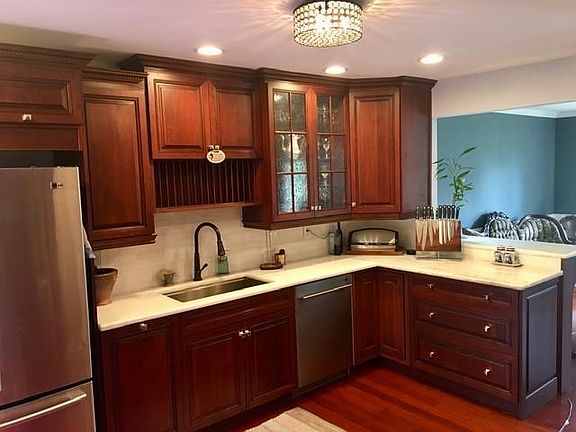 Beautiful cherry cabinets that go all the way to the ceiling; granite/quartzite counter tops