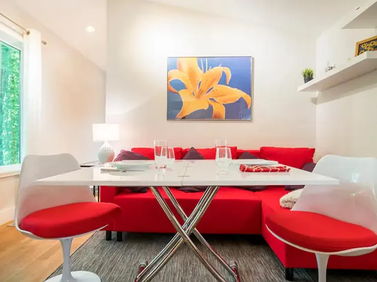 If you choose to lease the apartment furnished, the expanding table is shown here. Also included: white curtains, side table, lamp. NOT included: couch and chairs and artwork.