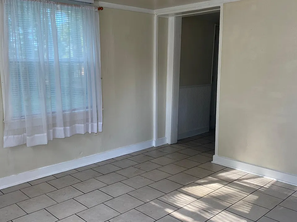 Light and airy living room, all floors are ceramic tile, double-hung vinyl windows with screens
