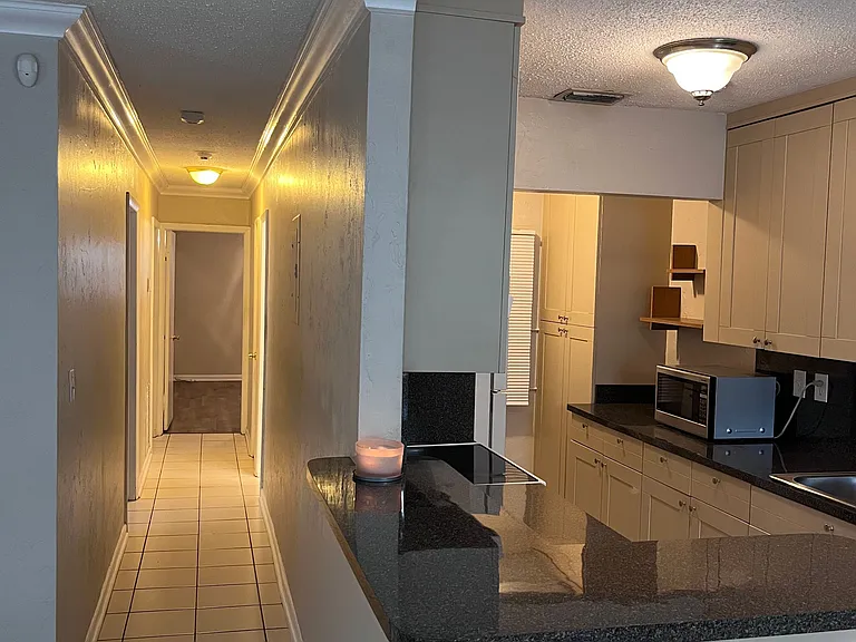 Hallway that leads to, bedroom 1 (on left), double sink bathroom (on right), large bedroom at end of the hallway and master bedroom (last door on the left)