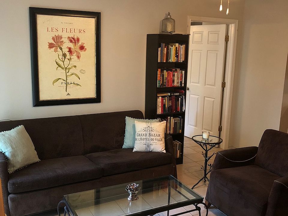 Large living room space with tile floors.